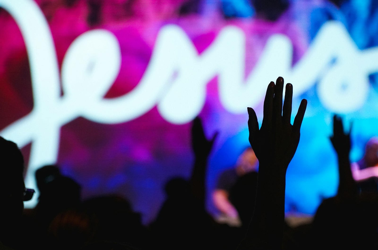 Students worshiping with hands raised